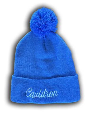 Light blue beanie with pom-pom and 'Cauldron' script embroidery